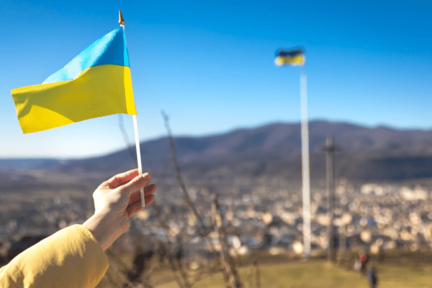 Hand holding Ukrainian flag