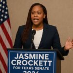 Jasmine Crockett speaking at a podium during her 2026 Texas Senate campaign announcement, with an American flag in the background.